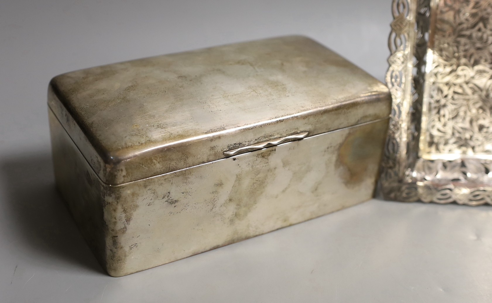 A George V silver mounted rectangular cigarette box, Birmingham, 1911, 17.2cm and an engraved white metal small tray.